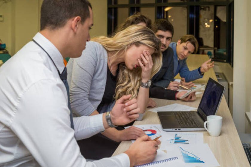 Frustrated project team facing delays and miscommunication during a project review meeting
